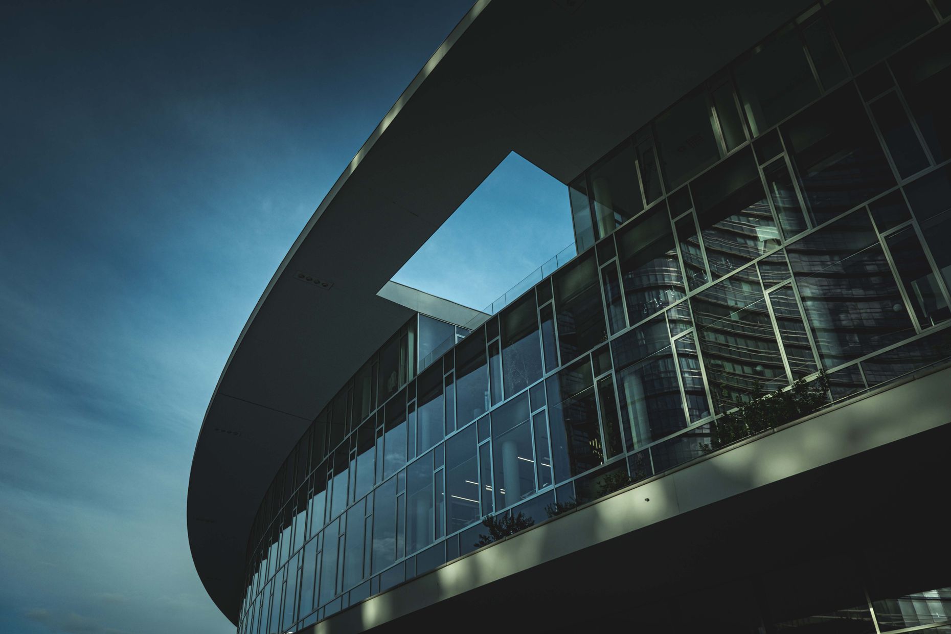 Modern glass building facade at dusk